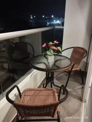 a glass table and two chairs on a balcony at Apartamento en San Miguel hermosa vista al mar in Lima