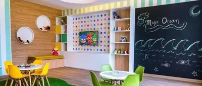 a classroom with two tables and chairs and a chalkboard at Apartamento en San Miguel hermosa vista al mar in Lima