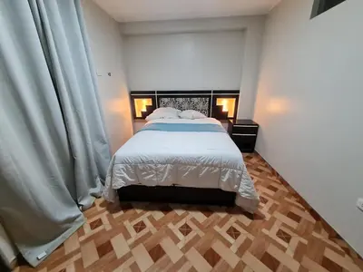 a bedroom with a bed with white sheets and white pillows at apartment MAGIC in Ayacucho