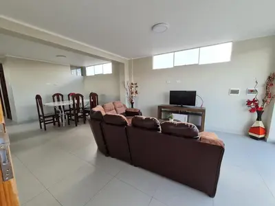 a living room with a brown couch and a table at apartment MAGIC in Ayacucho
