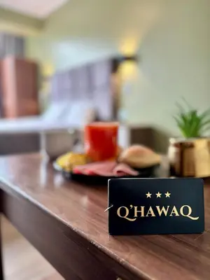 a black sign on a counter with a plate of food at Hotel Qhawaq Huancayo in Huancayo