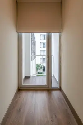 an empty room with a large window and a wooden floor at The Oak 2BR by Geko in Lima