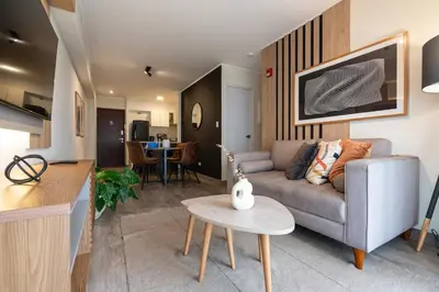 a living room with a couch and a table at The Oak 2BR by Geko in Lima