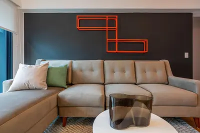 a living room with a couch with a vase on a table at Zafira 1BR by Geko in Lima