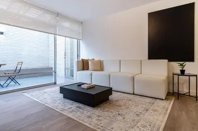 a living room with a white couch and a coffee table at Zebbra 1BR by Geko in Lima