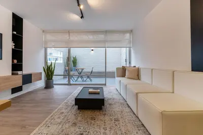 a living room with a white couch and a coffee table at Zebbra 1BR by Geko in Lima