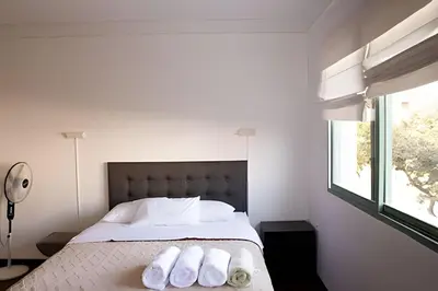 a bedroom with a bed with two towels on it at Casa en el corazón de Miraflores in Lima