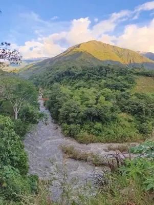 a view of a mountain with a river and trees at Bella Victoria Ecolodge in Santa María