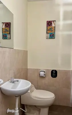 a bathroom with a sink and a toilet at Paracas Ayni in Paracas