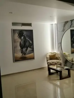 a living room with a chair and a mirror at Loft and reception RISHEL in Chincha