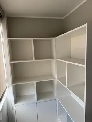 a walk in closet with white shelves at Loft and reception RISHEL in Chincha