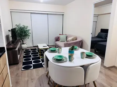 a living room with a table and a couch at Monterrico Polo Aparts #22- Dpto 2 Dorm 2 baños - Frente Embajada USA in Lima
