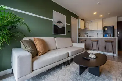 a living room with a couch and a table at Bagheera 2BR by Geko in Lima