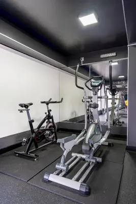 a gym with two exercise bikes in a room at Stelar by Geko in Lima