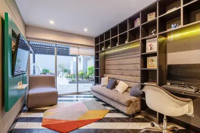 a living room with a couch and a desk at Stelar by Geko in Lima