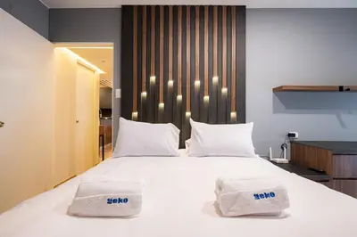a bedroom with a large bed with two white pillows at The Rooftop 2BR by Geko in Lima