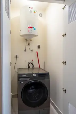 a washer and dryer in a laundry room at Miraflores Modern Apartments Benavides by Geko in Lima