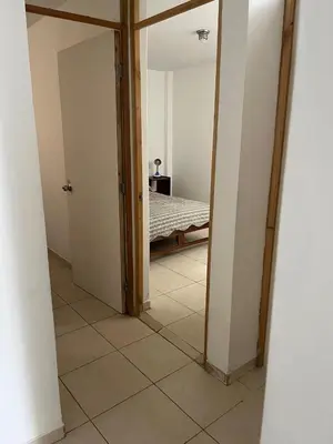 a hallway with a bedroom with a bed in it at Punta Hermosa - depa Santa Cruz in Punta Hermosa