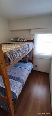 two bunk beds in a small room with a window at 4 habitaciones in Lima