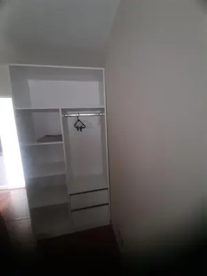 a small white refrigerator with a door in a room at 4 habitaciones in Lima