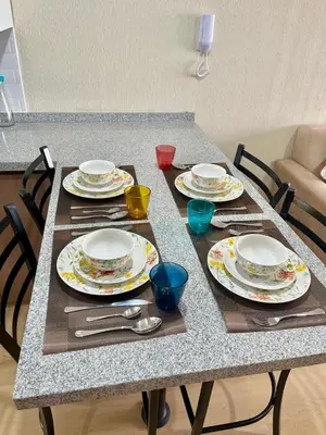a table with plates and utensils on it at Encantador departamento con hermosa vista in Lima