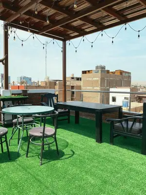 a patio with tables and chairs on a roof at Habitación Privada con Entrada Independiente in Ica