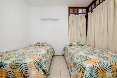 a bedroom with two beds and a window at casa de campo en cieneguilla in Cieneguilla