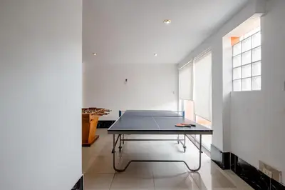 a ping pong table in the middle of a room at casa de campo en cieneguilla in Cieneguilla