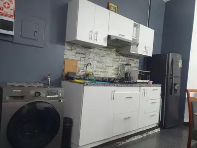 a kitchen with a washing machine and a refrigerator at Beautiful private office in Miraflores in Lima