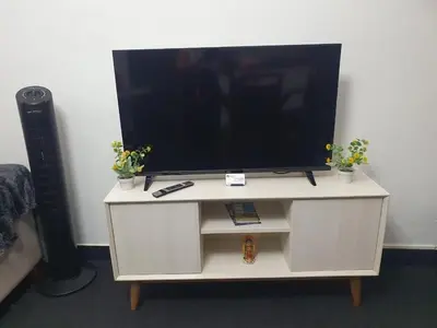 a tv on top of a white entertainment center at Beautiful private office in Miraflores in Lima