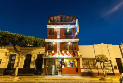 a tall building with a tower on top of it at Hostal Iquique in Lima