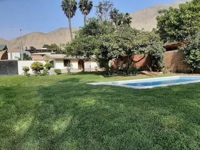 a yard with a swimming pool in front of a house at Country house cieneguilla in Cieneguilla