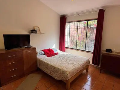 a bedroom with a bed and a tv and a window at Country house cieneguilla in Cieneguilla