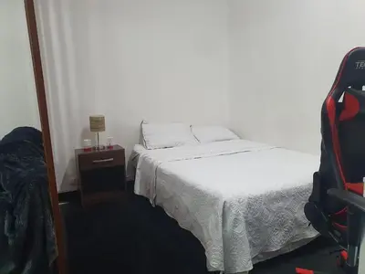 a small bedroom with a bed and a mirror at Hermosa oficina privada en Miraflores in Lima
