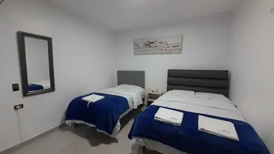 a room with two beds and a mirror at La Rinconada de Churin in Churín