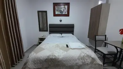 a bedroom with a bed and a table and a table at La Rinconada de Churin in Churín