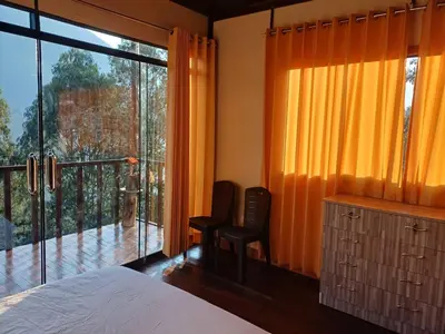 a bedroom with a bed and a large window at Ecoterra Inka Lodge in Quillabamba