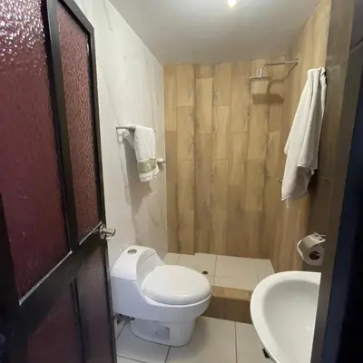 a bathroom with a toilet and a sink and a shower at Casa La warida con tres niveles in Ayacucho