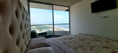 a bedroom with a bed and a large window at Departamento con Vista al Mar San Miguel in Lima
