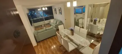 a small living room with a table and a couch at Departamento con Vista al Mar San Miguel in Lima