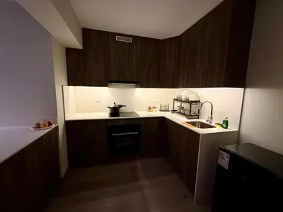 a small kitchen with wooden cabinets and a sink at Rest, comfort and privacy in San Isidro in Lima