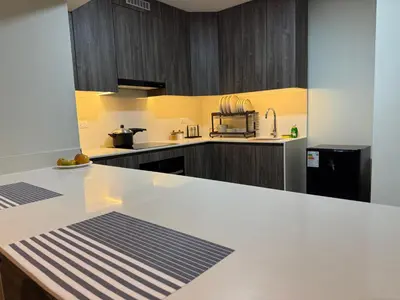 a kitchen with a white counter top and wooden cabinets at Rest, comfort and privacy in San Isidro in Lima