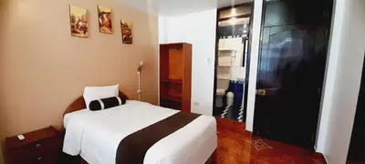 a small bedroom with a bed and a closet at El Tambo Machupicchu in Machu Picchu