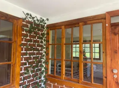 a room with two windows and a brick wall at Casa de Campo Miraflores in Oxapampa