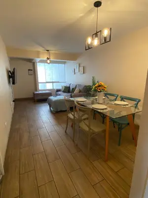 a living room with a table and a couch at Hermoso departamento estreno céntrico in Lima