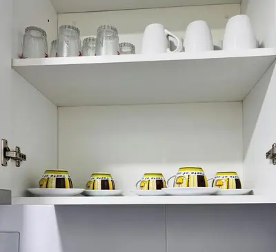 a kitchen shelf with cups and plates on it at Hermoso departamento estreno céntrico in Lima