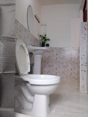 a bathroom with a white toilet and a sink at INKA's WALK in Cusco