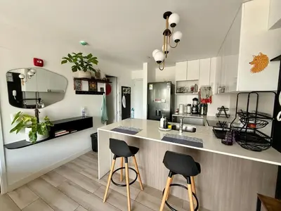 a kitchen with a counter and two stools at Rest and comfort in San Isidro in Lima