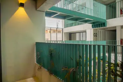 a staircase with green railings in a building at Arrieta by Wynwood House in Lima