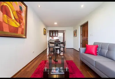 a living room with a couch and a table at Apartamento en Miraflores in Lima